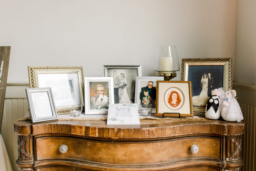 Photos of past generations at a wedding display table