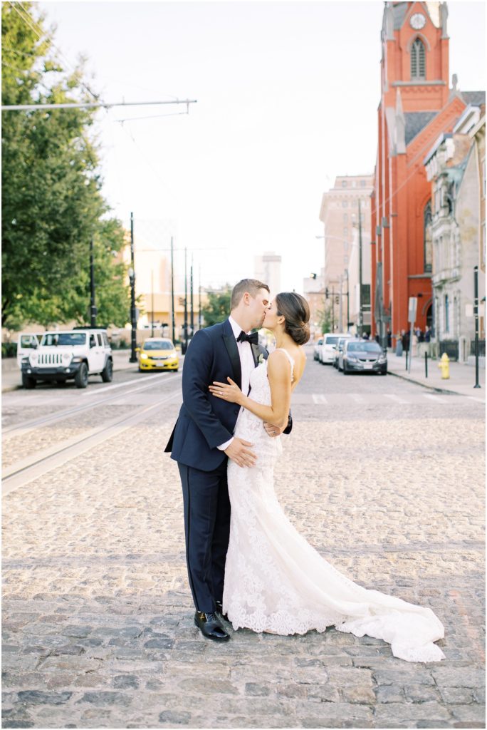 Photo of a couple kissing in the middle of the street downtown on their wedding day in Cincinnati, Ohio