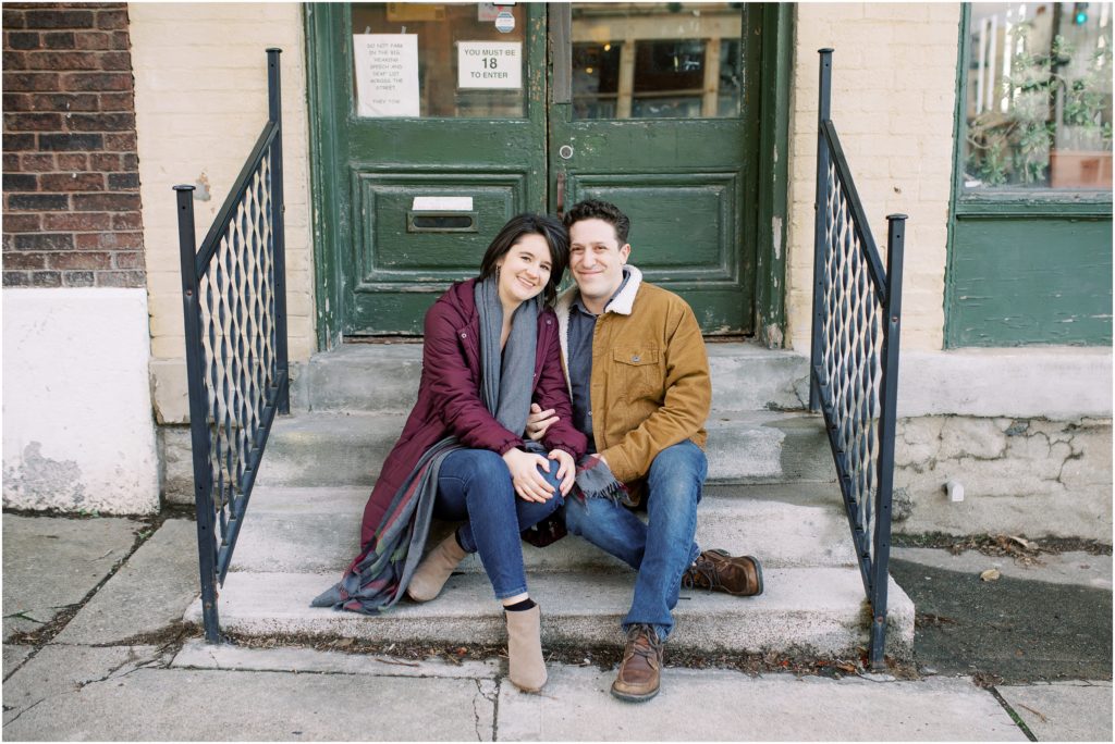 Couple sits at the steps of the coffee shop that they had their first date