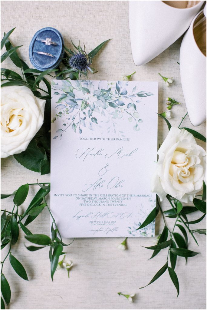 Wedding Invitation flat lay with florals and greenery 