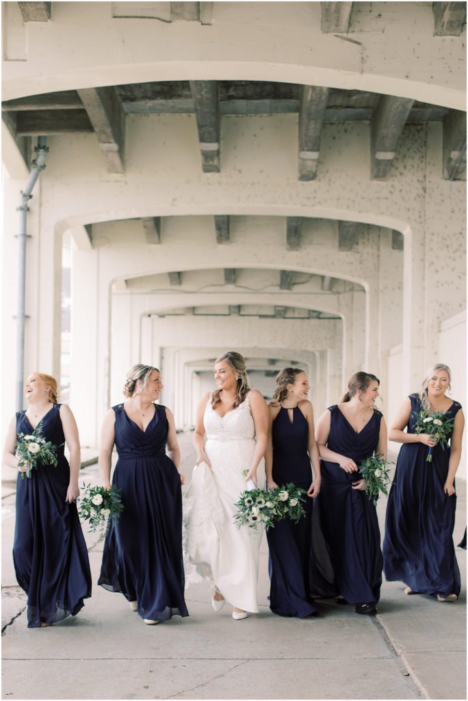 Bridal party under a bridge during the rain in Cincinnati, Ohio