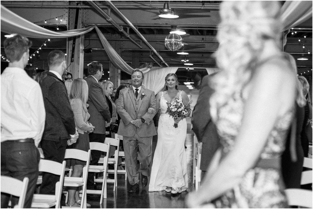 Bride walking down the aisle during a wedding ceremony at Longworth Hall in Cincinnati, Ohio